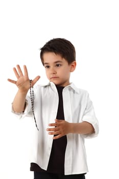 male child playing with rosary for pray