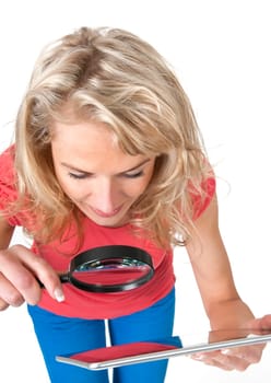 Woman with magnifying glass and digital tablet