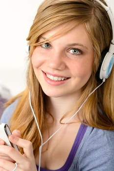Portrait of a teenage girl listening to music with headphones