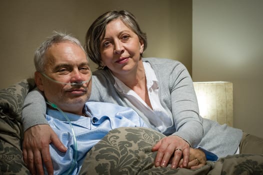 Mature couple wife supporting ill husband at home