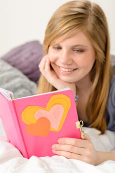 Friendly young girl reading her journal of memories
