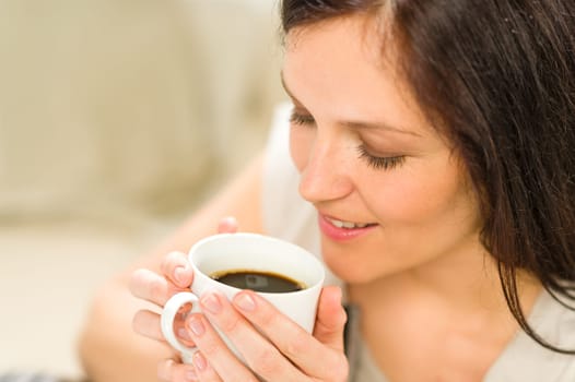 Cute woman holding cup of hot refreshing coffee