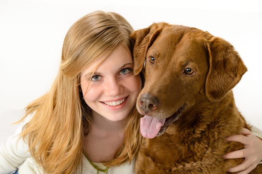 Cute girl holding a dog over white background