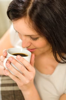 Relaxing woman drinking hot beverage for enjoyment