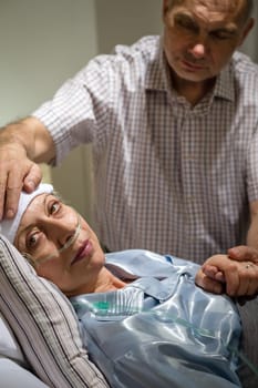 Loving husband taking care of seriously sick mature wife