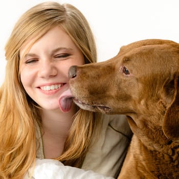 Portrait of a pretty girl snuggling with her dog