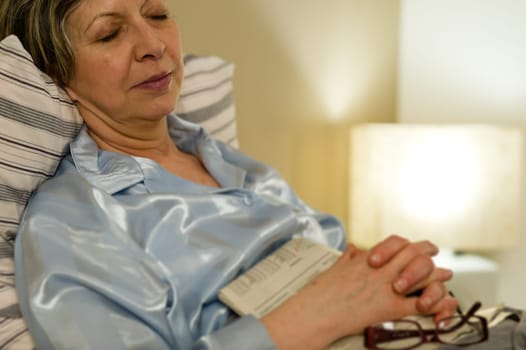 Peaceful portrait of sleeping old woman in bed