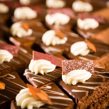 Tastefully decorated chocolate cake pieces with whipped cream