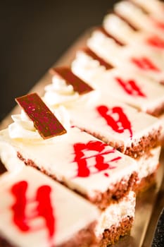 Chocolate cakes filled with vanilla cream decorated with icing