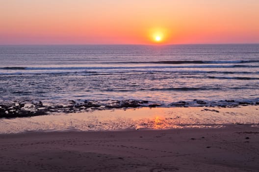 Sunset on Atlantic coast of Portugal at Praia da Areia Branca