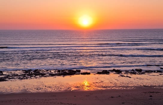 Sunset on Atlantic coast of Portugal at Praia da Areia Branca