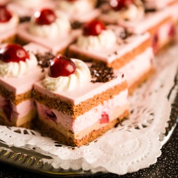 Cherry cream filled sponge cakes with whipped cream topping