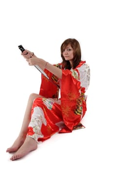 french young girl geisha in red silk kimono with japanese sword