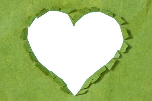 Close-up of a ripped  heart in a green paper