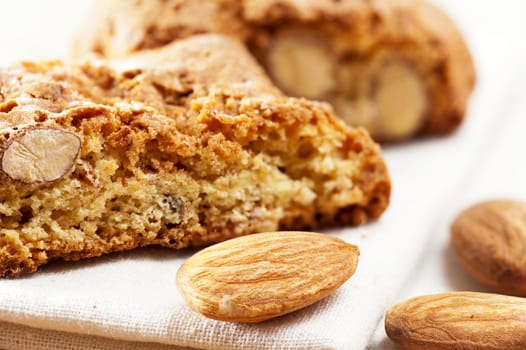 Cantuccini pastries and almond kernels as a close-up lying on a tablecloth