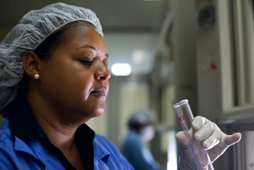 People and science, staff member at work as chemist doing test in industrial lab