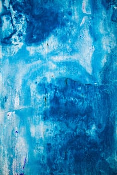 Faded blue painted wall background texture with white streaks