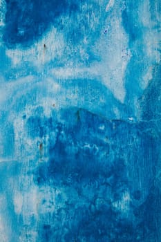 Faded blue painted wall background texture with white streaks