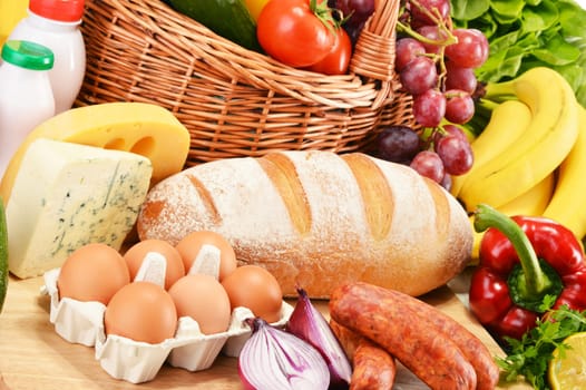 Assorted grocery products including vegetables fruits wine bread dairy and meat