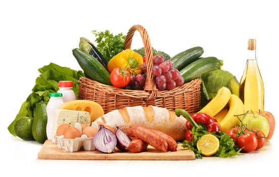 Assorted grocery products including vegetables fruits wine bread dairy and meat isolated on white