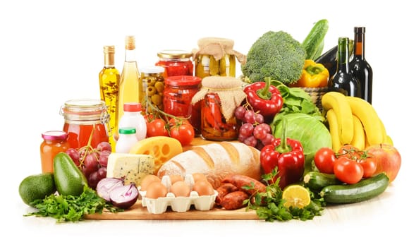 Assorted grocery products including vegetables fruits wine bread dairy and meat isolated on white