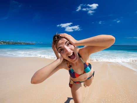 Beautiful and happy young woman  enjoying the summer on a tropical beach