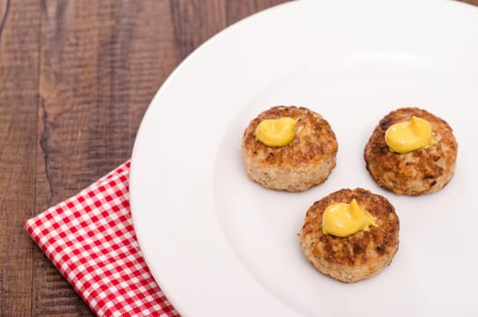 Meatballs with mustard on a plate