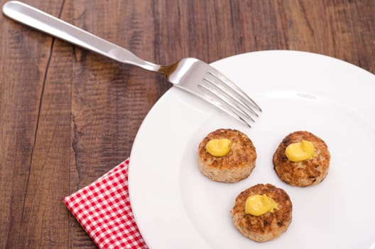 Meatballs on a white plate with fork