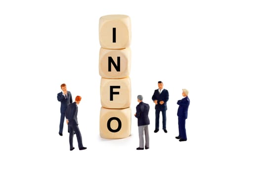 Model figures of businessmen with cube and lettering - cropped on a white background
