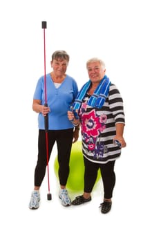 Seniors with swinging stick and gymnastics ball - cropped on white background