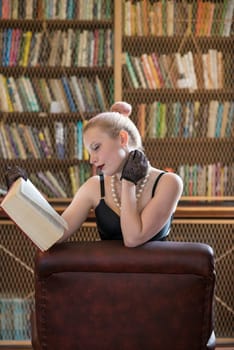 Beautiful caucasian woman reading book in old library