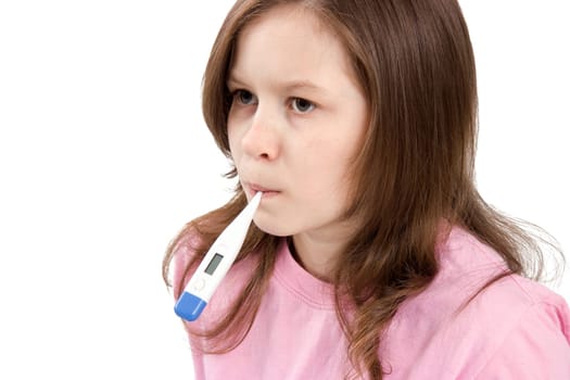 The girl holds a thermometer in a mouth