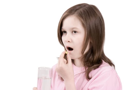 The girl is going to eat a tablet and to wash down with its water