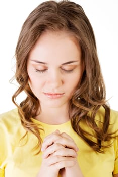 young pretty caucasian girl praying over white background.