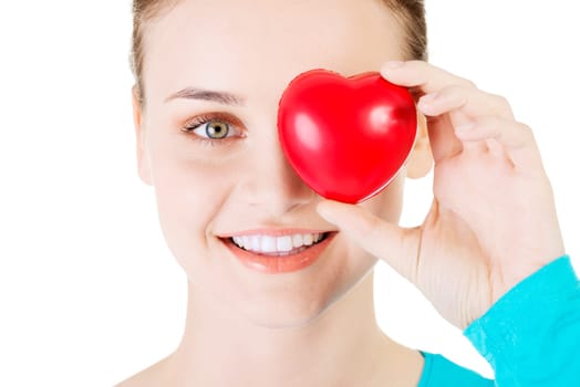 pretty girl showing a red heart in her hand over white.