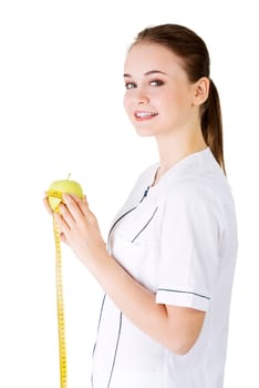 healthy eating or diet concept. smiling woman doctor with a green apple and measuring tape.