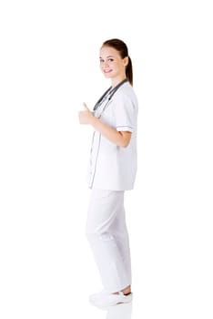 young female doctor or nurse gesturing ok,isolated on white.