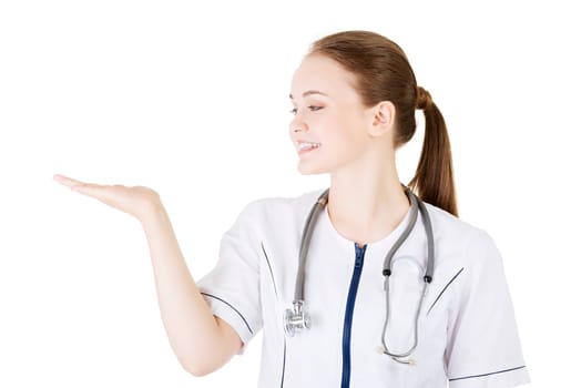 medical doctor woman presenting and showing copy space for product or text.