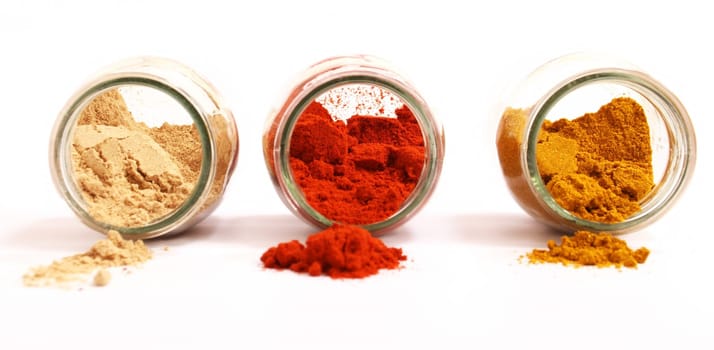 Variety of spices in a glass pot, focus in the back.