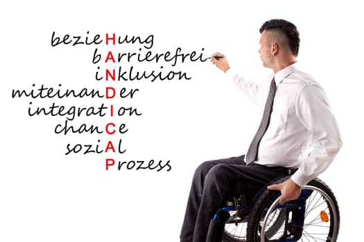 disabled man writes on blackboard
