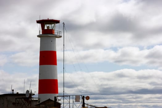 Beacon photo ashore against the cloudy sky