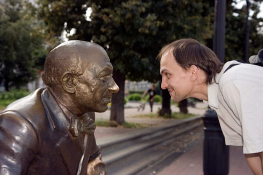 The young man looks in the face to a statue