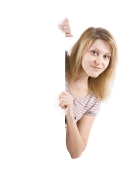 On white background the smiling young woman behind the white stand