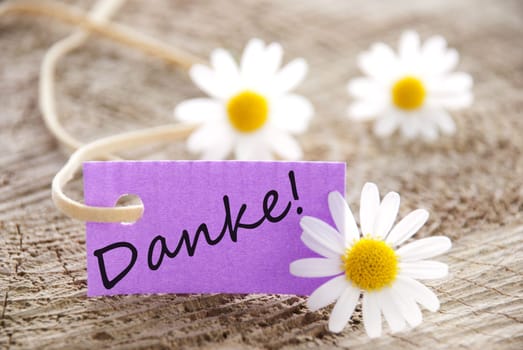 a purple label with the german word Danke which means thanks, flowery background