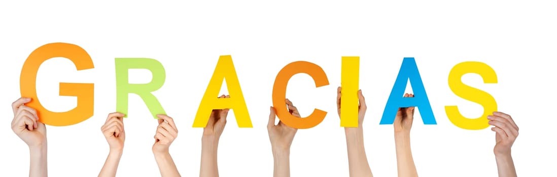 many hands holding the spanish word gracias which means thanks, isolated