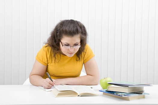 girl student sitting at a table in the classroom