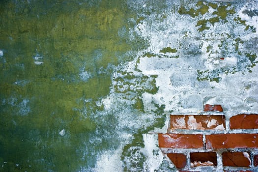 old peeling walls with plaster and brick
