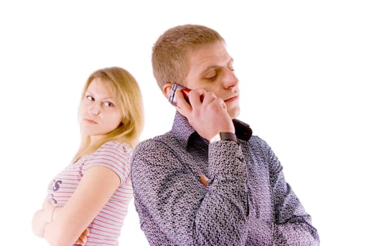 A problem of young families. Man talking on the phone, forgetting about his wife