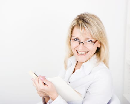 a young attractive blonde with glasses and a book