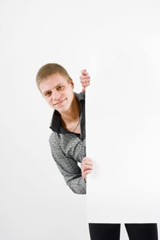 young man with a blank placards on a light background